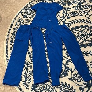 Xfinity Cherokee Royal blue XS scrubs. Worn but very slimming fit.